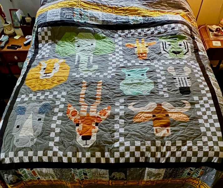 A quilt with faces of animals